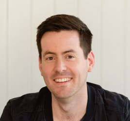 a man with dark hair and a black T-shirt